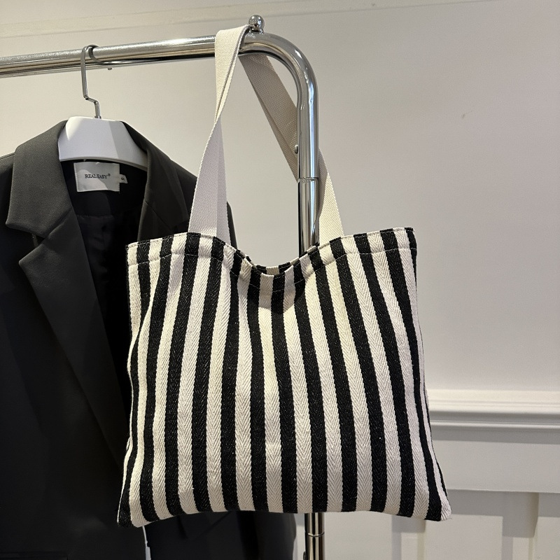The new cross-border vertical striped commuter tote bag, hand-held shoulder bag, is fashionable and has a large capacity. It features an InS-style simple letter sail undefined