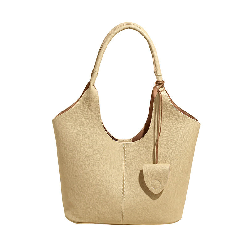 Versión coreana del bolso de alta capacidad 2025 nuevo bolso de cubo de todo fósforo de moda bolso de hombro simple bolso de axila de color sólido
