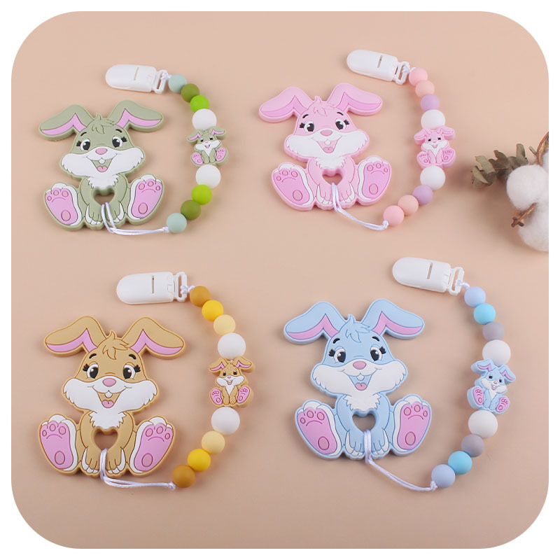 Amazon nuevo bebé suministros de dibujos animados conejo de silicona juguete mordedor pezón anti-gota cadena molar traje