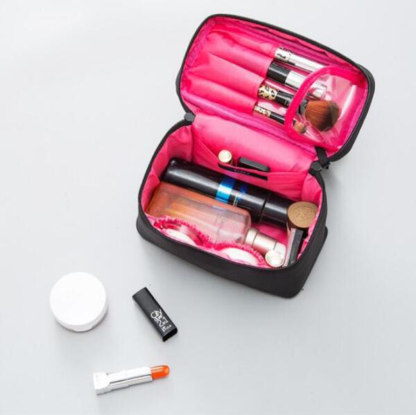 Capacious handheld cosmetic bag
