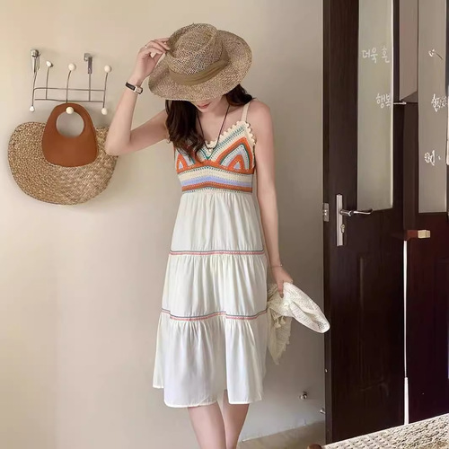 Retro ethnic-style designer V-neck knitted sweater with patchwork, paired with a long beach-style slip dress—women's clothing.