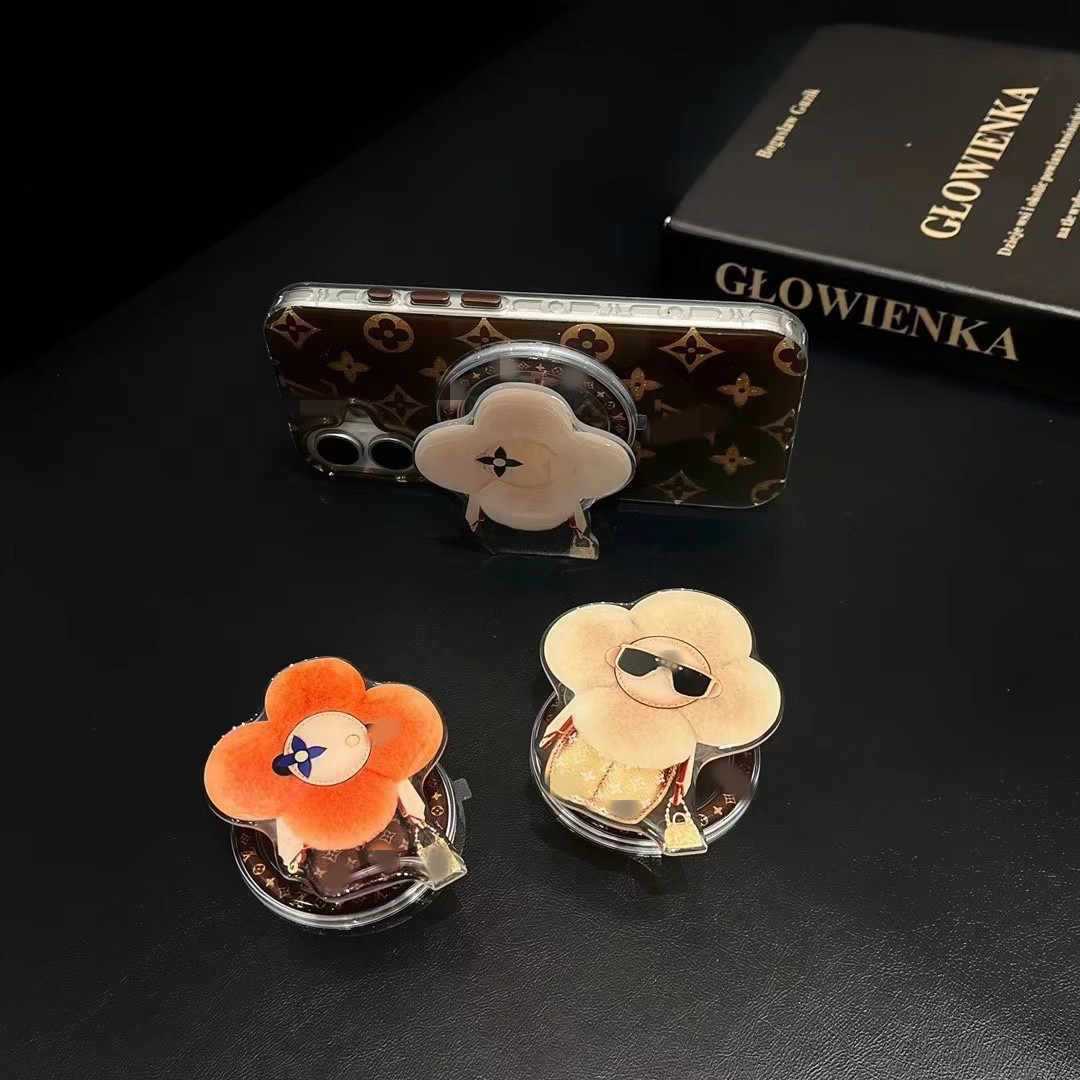 新型高級マグネットスタンドマグネット式携帯ケース通用太陽花マグネット式エアバッグスタンドはおしゃれで豪華です。