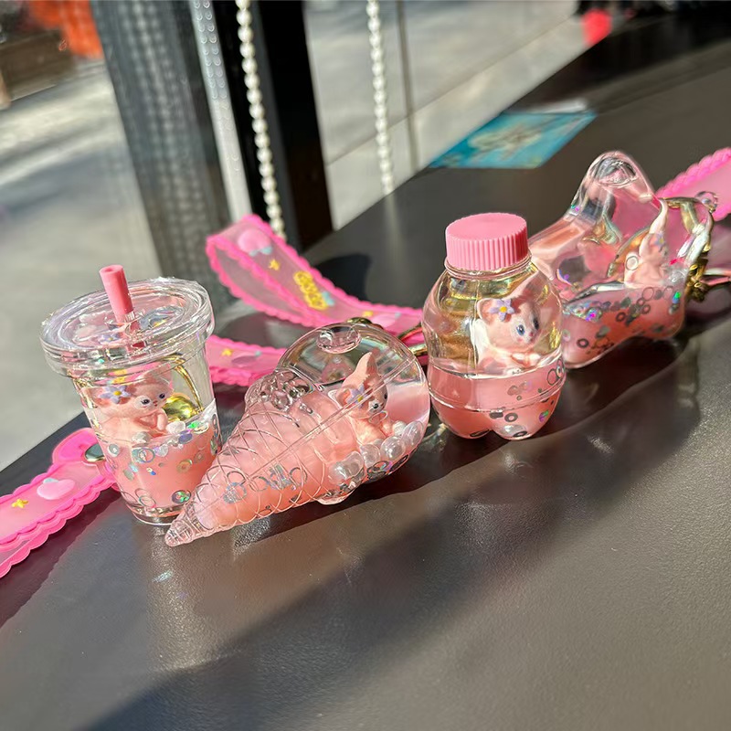 Fábrica al por mayor arena flotante explosión llavero chatter ling nabel agarrar muñeca máquina colgante llavero regalo para niños llavero