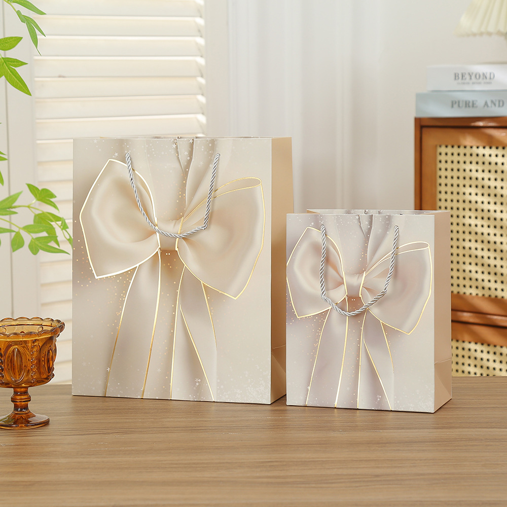 Bolsas de regalo de San Valentín bolsas de embalaje de arco bolsas de regalo de vacaciones Qixi papel cartón blanco estampado bolsas al por mayor