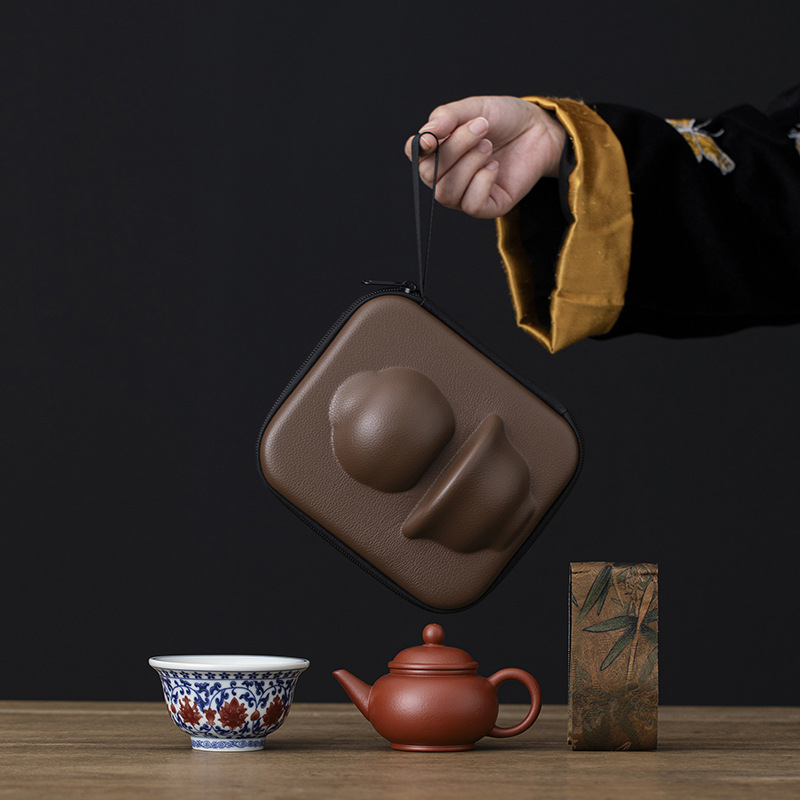 A portable travel tea set for one person, including a teapot and a cup, made of original purple clay with a horizontal design and a lotus pattern