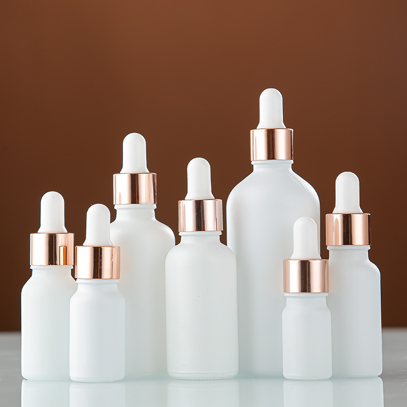 Venta al por mayor aerosol blanco botella de aceite esencial botella cosmética sub-botella 30ml esencia líquida botella redonda botella de plástico cabeza cuentagotas