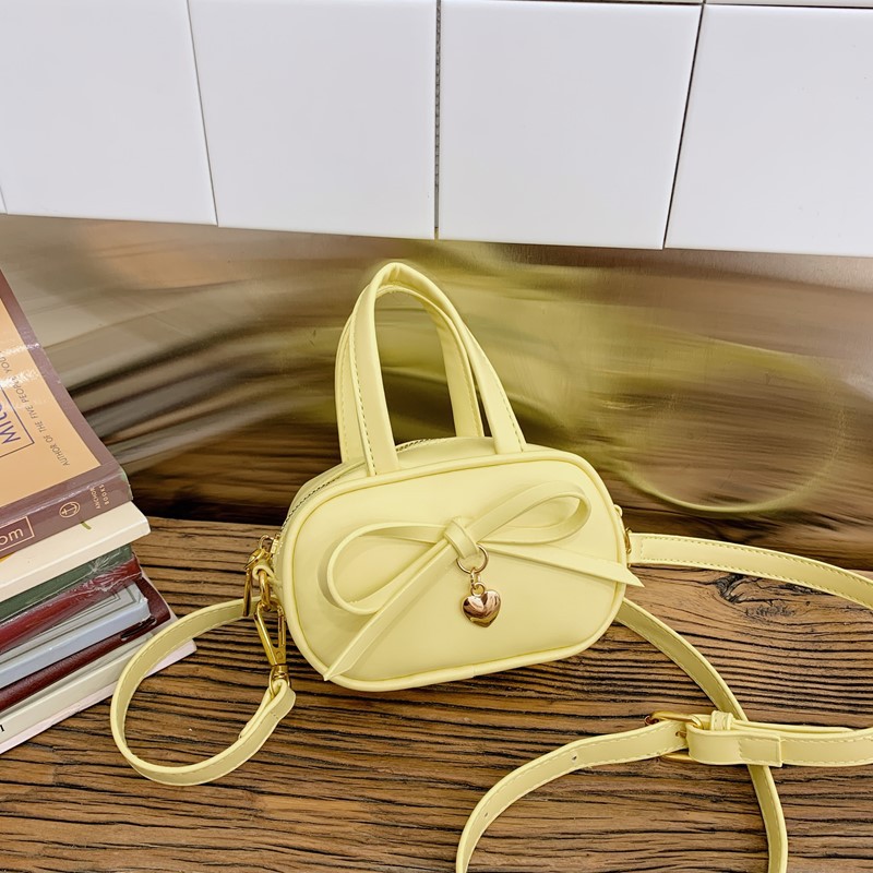 Coreano simple color sólido bolso de hombro para niños y niñas mini bolso de bebé lindo dulce bolso de arco para niños