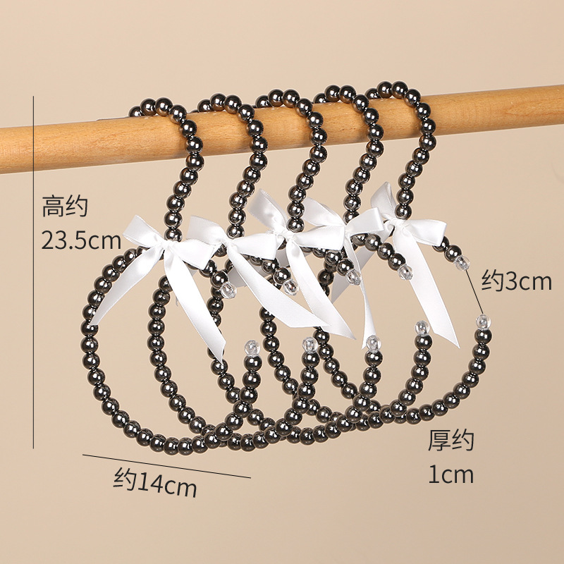 Tienda de ropa de mujer perla lujo ligero vestido retro arco adulto percha de ropa infantil estilo europeo hadas soporte de abrigo