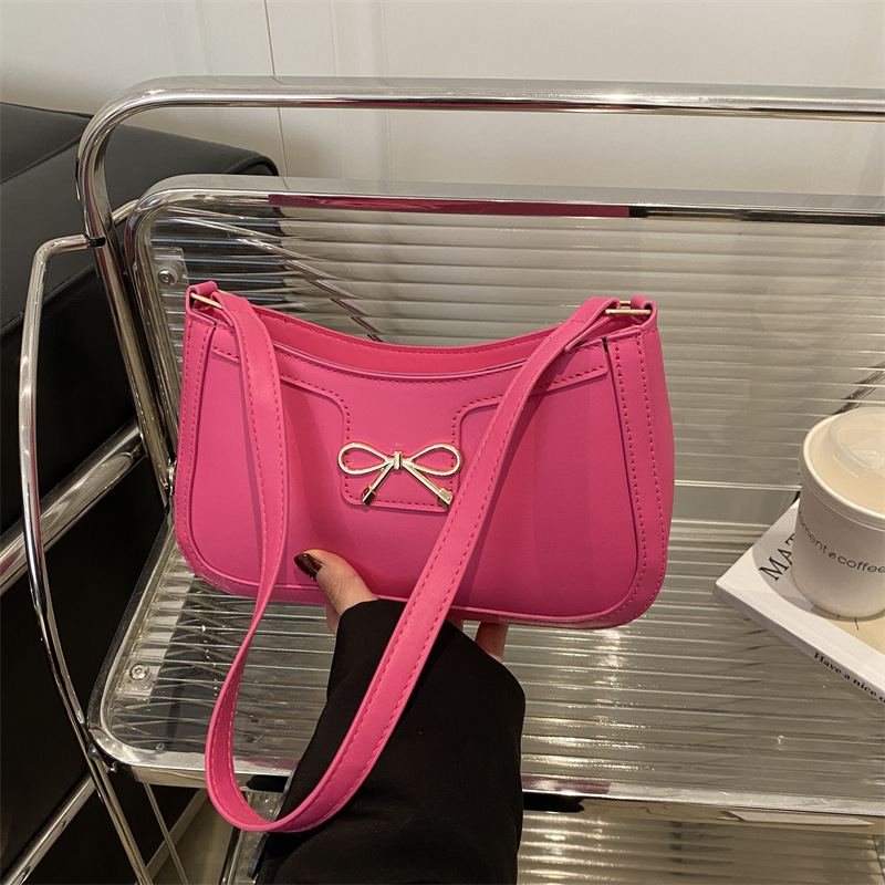 Bolso de hombro popular de este año con lazo para damas de gran capacidad 2025 color sólido nuevo bolso de axila simple de textura de moda