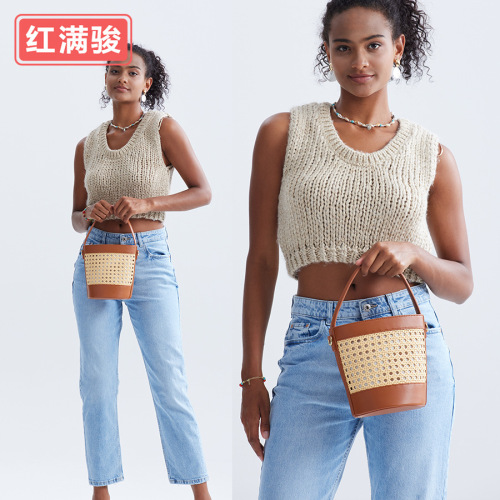 New handmade woven rattan bucket bag for women: chic hollowed-out drawstring tote perfect for beach vacations, also a unique choice as a shoulder or crossbody bag.