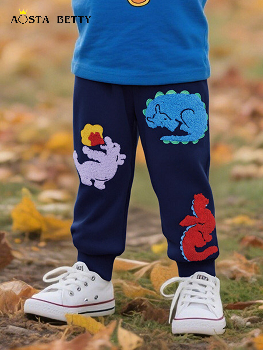 Otoño nuevos pantalones para niños estilo europeo y americano moda pantalones para niños dibujos animados dinosaurio toalla bordada pantalones deportivos para niños