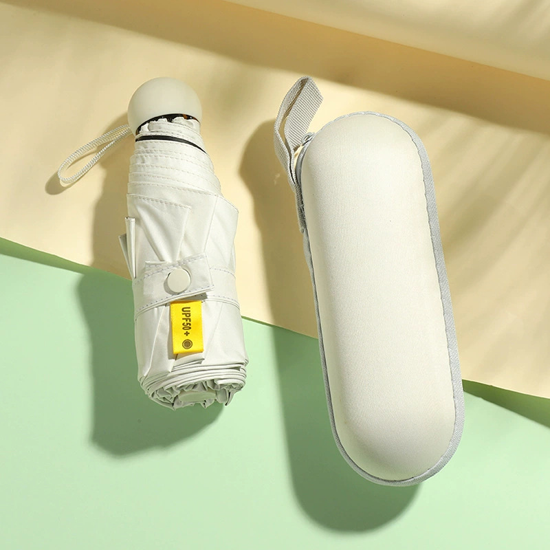 50% de descuento paraguas de cápsula de seis huesos paraguas de Sol de doble uso pequeño paraguas de bolsillo portátil simple pegamento negro paraguas de protección solar al por mayor