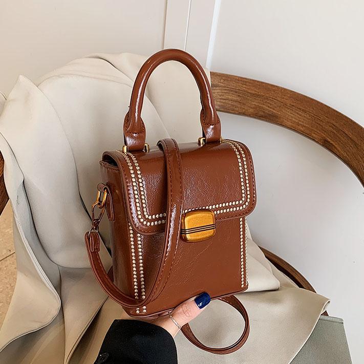 Retro versátil bolso de mano para mujeres 2025 nuevo nicho de alto nivel sensación de hombro mochila de moda bolso móvil