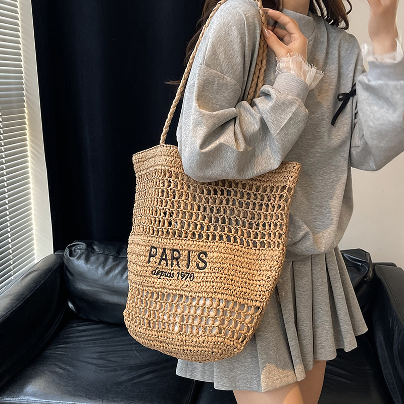 Bolso tejido de paja de moda casual para damas de gran capacidad 2025 nuevo bolso de hombro hueco tejido coreano bolso de playa
