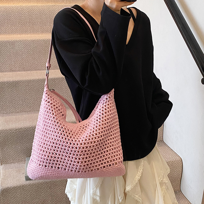 Venta caliente de verano nuevo producto bolsa tejida hueca para mujer 2025 bolsa de playa estilo vacaciones bolsa de paja de gran capacidad bolsa de cubo