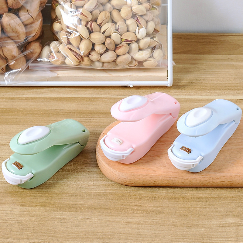 Hogar portátil mini bolsa de plástico máquina de sellado snack pequeña presión de mano máquina de sellado de calor máquina de sellado de plástico clip de sellado venta al por mayor