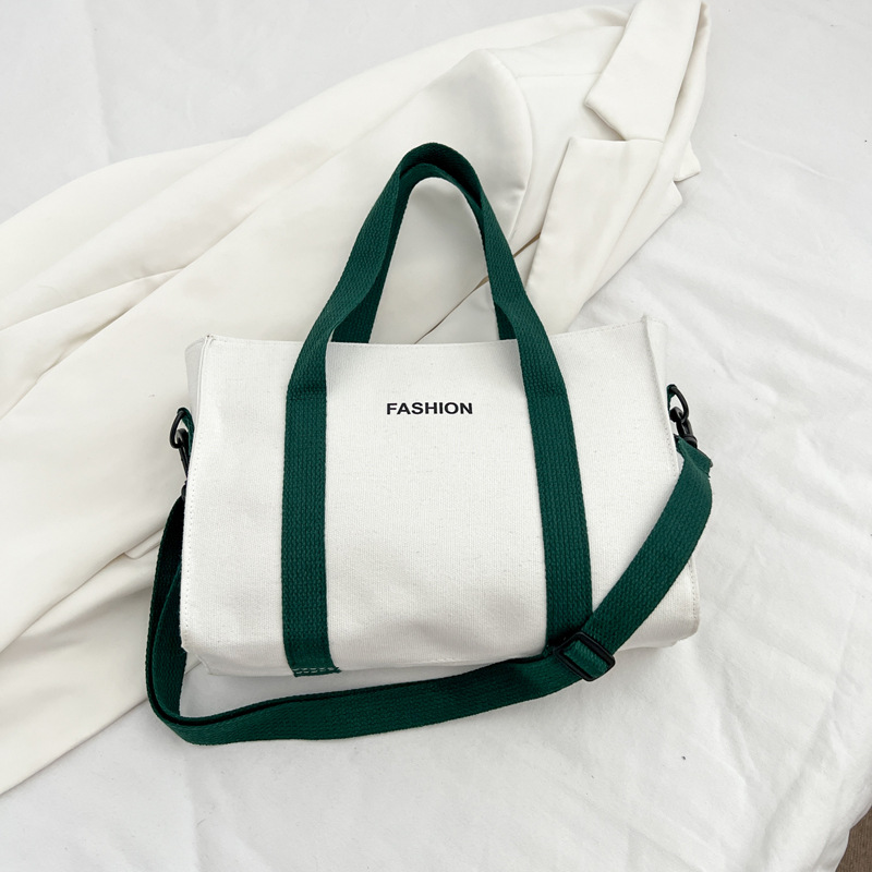 2024 nuevo simple japonés blanco y negro bolso de tela de gran capacidad para estudiantes de clase de viaje mochila de hombro