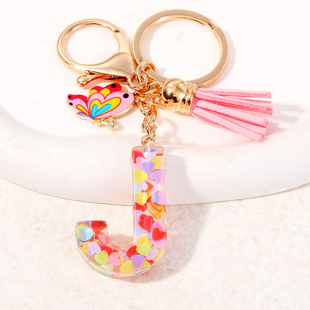 2024 puntos transfronterizos de resina de sequilla rosa 26 letras inglesas llavero colgante mariposa fringe accesorios