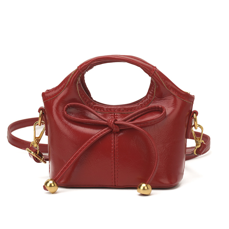 Bolsas infantiles transfronterizas de moda coreana de color sólido, bolsas de mano de chicas, mini bolsas de cestas de arco lindas