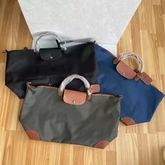 高バージョンの牛革と暗号化ナイロンの大型餃子バッグ、ユニセックストラベルバッグ、大容量の手荷物バッグ