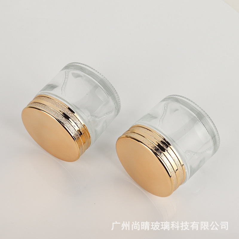 Venta caliente en stock 50g rollo arena tapa crema botella cosmética vidrio cuidado de la piel botella cubierta de plástico dragón de oro crema de sangre
