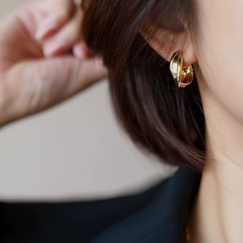 A pair of bright gold earrings [copper plated with real gold]
