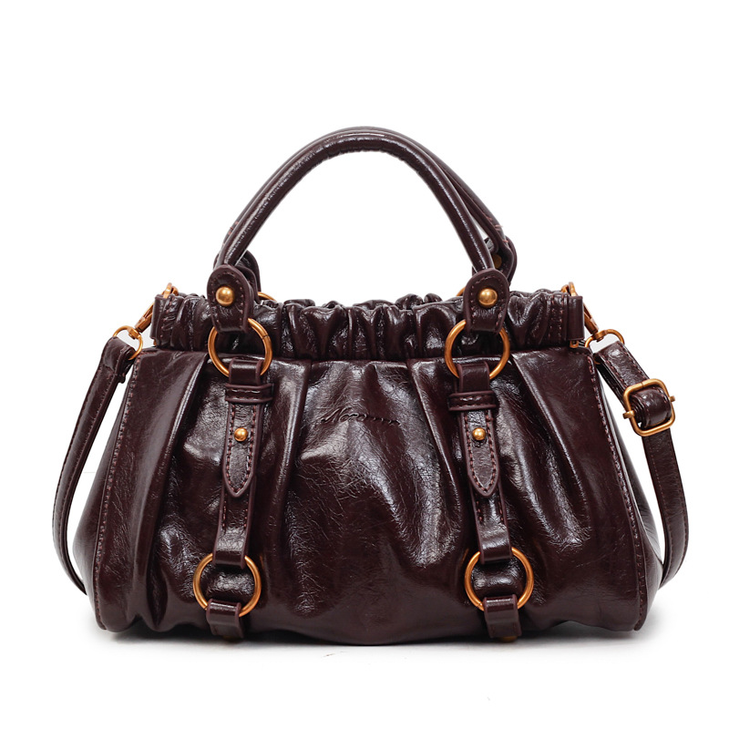 Retro bolso de mano plegable mujer 2025 otoño y invierno nuevo nicho de diseño bolso de cubo de viaje mochila de hombro