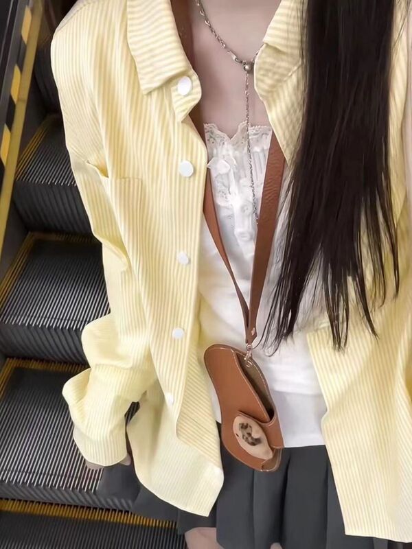春と秋のストライプのシャツの女性の中には、日本のゆったりとした長袖のシャツを重ねて着ています。|undefined