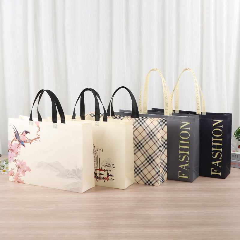 Bolsa de mano no tejida multi-especificación plegable con regalo de mano bolsas de compras de mano logotipo impresa en color bolsas de tela no tejida