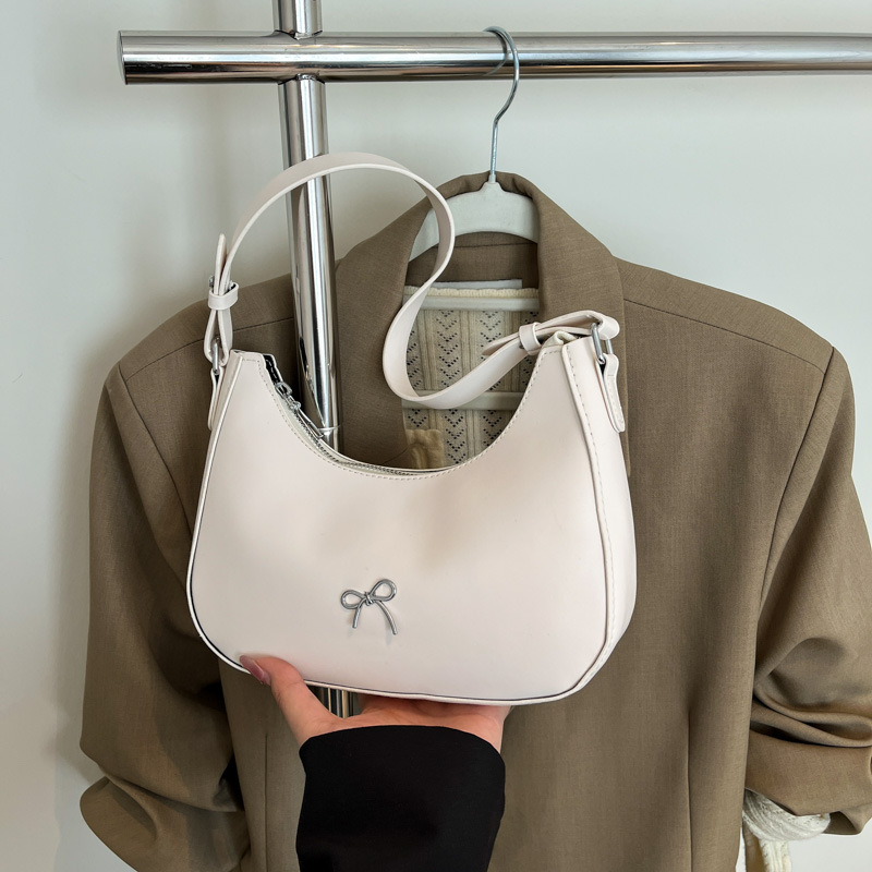 Nueva moda bolsa de color sólido textura 2025 casual bowknot bola de masa bolsa de axila de un solo hombro bolsa de media luna negro