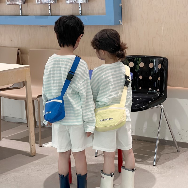 Moda coreana popular para niños y niñas bolsas de cintura letras extranjeras bolsas de mochila para bebés 2026 nuevo bolso de cambio para niños