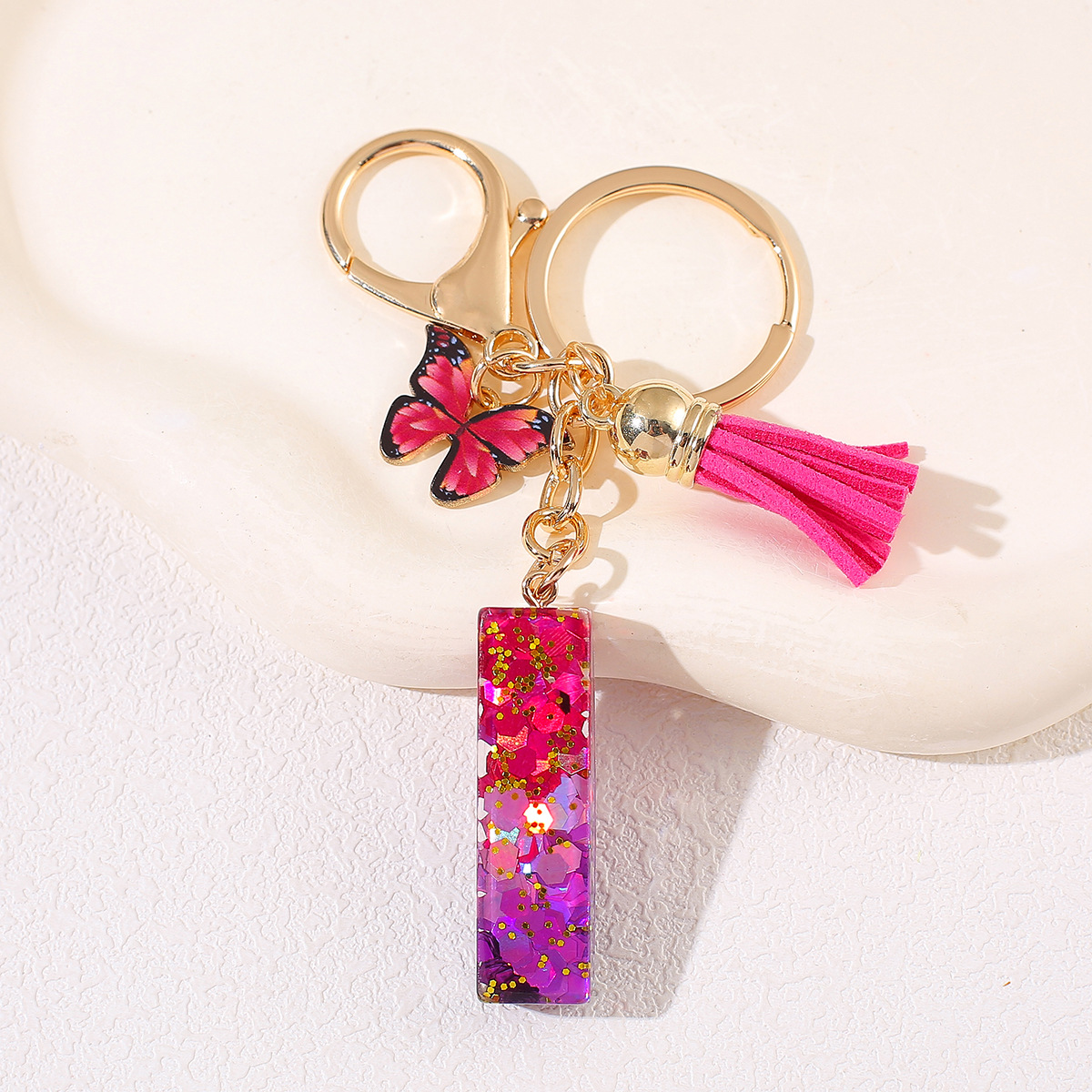 Transfronterizo Amazon 26 letras llavero de goteo de goma esquinilla gradiente letras mariposa llavero bolso de mujer colgante