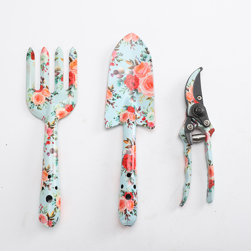 Herramientas al aire libre textura de impresión de flores pequeñas herramientas de jardín conjunto de tres piezas de impresión pala jardín flores y plantas herramientas de jardinería