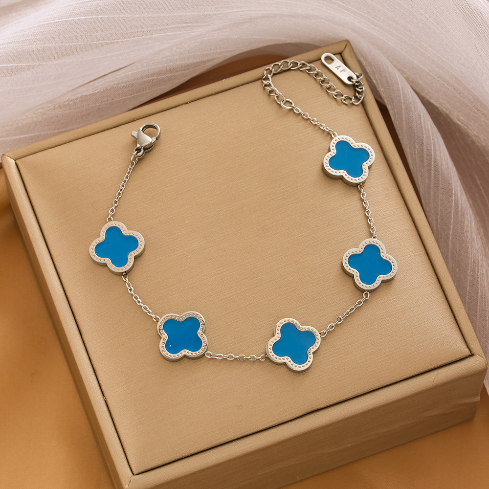 Pulsera de trébol de acero titanium vendedora caliente transfronteriza europea y americana con incrustaciones de concha pulsera colgante pulsera de diseño avanzado sin desvanecimiento al por mayor