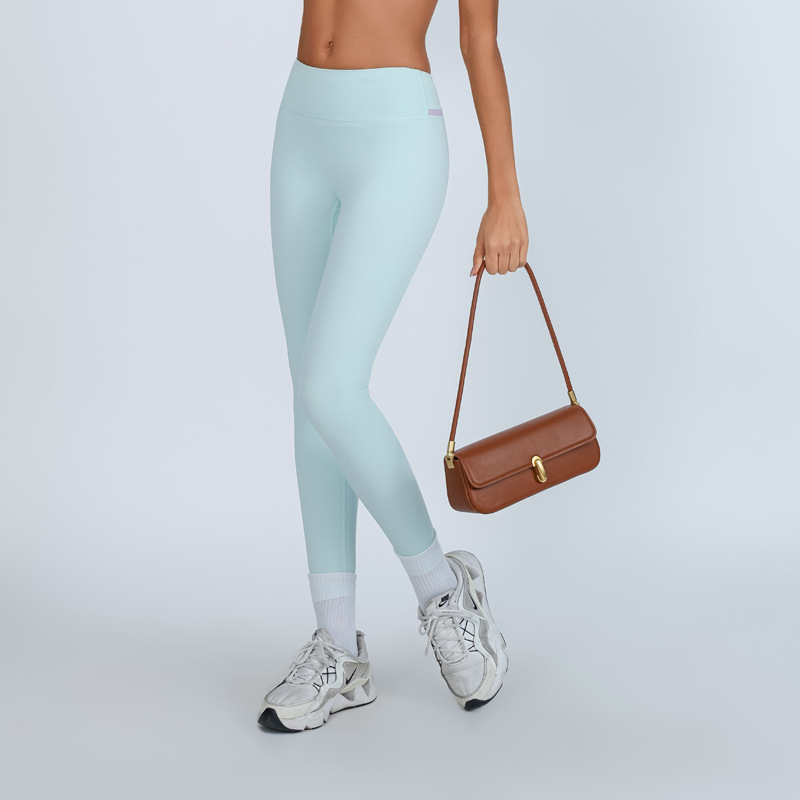 Nuevo estilo transfronterizo europeo y americano de contraste de color de cintura alta ajustada de secado rápido desnudo pantalones de yoga de nueve puntos para esculpir el cuerpo y levantar las caderas