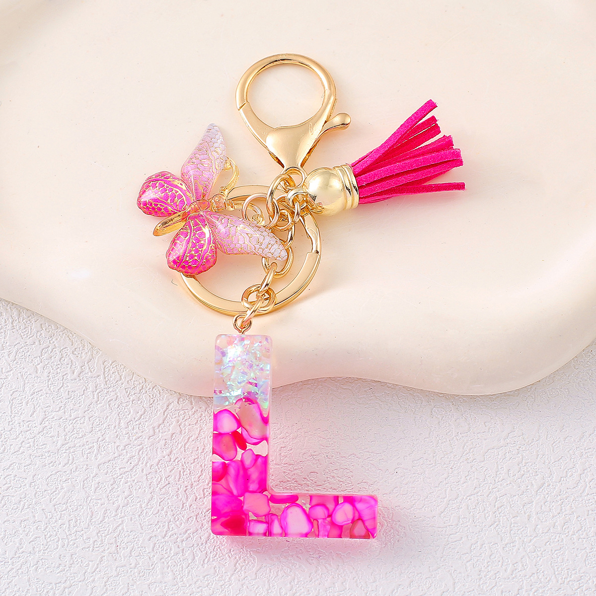 2024 explosión llavero joyería de resina letras bolsos colgantes de dama conchas rojas llavero colgantes de mariposa