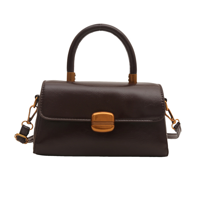 Nicho de diseño coreano bolso de mano 2025 primavera nuevo estilo simple de moda con cierre de flip de hombro monocolor bolso de mochila