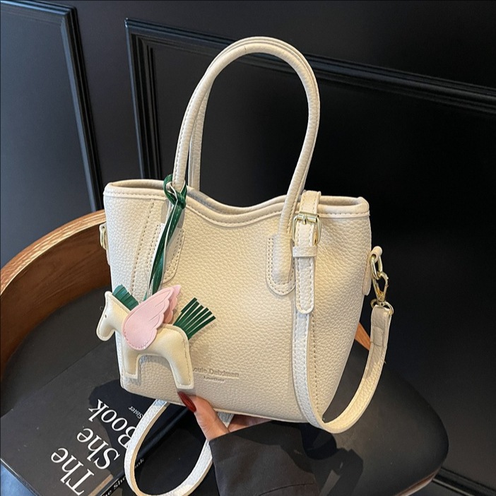 Bolsa de cubo portátil de estilo occidental de alta calidad para mujer 2025 nuevo bolso de mensajero de hombro de viajero de estilo explosivo de moda salvaje