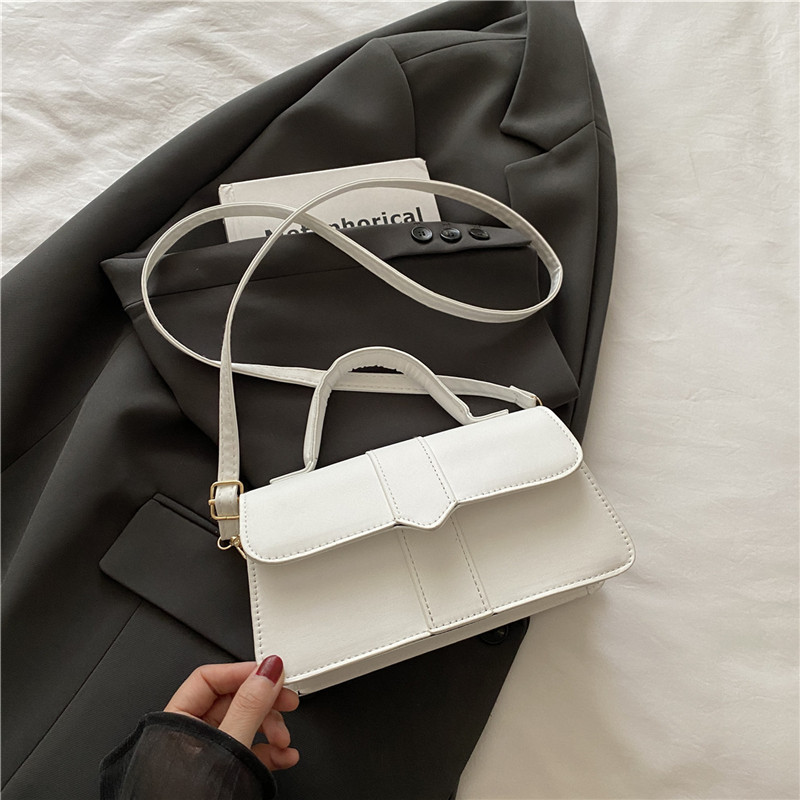 Bolso de color sólido de diseño de nicho para mujer 2025 nuevo bolso cuadrado portátil de moda de moda bolso de mensajero de alta gama de todo fósforo