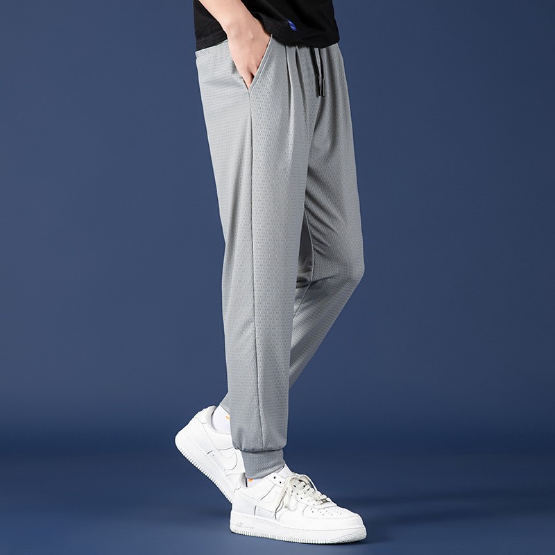 Malla transpirable pantalones atados al tobillo primavera y verano nuevos hombres de cintura elástica de seda de hielo deportes casuales pantalones de color sólido
