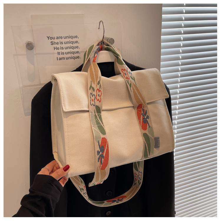 Comercio exterior bolsa de lona para las mujeres 2023 nueva moda japonesa y coreana bolsa de mano portátil nicho de alta calidad bolsa de mensajero del hombro