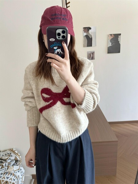 Demi-season knitted sweater with a round collar with bow