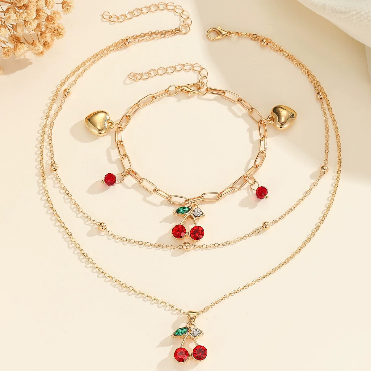 Оптовая продажа модных высококачественных ювелирных украшений: циркониевые колье и браслеты с вишневыми кристаллами в европейско-американском стиле.