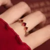 Burgundy three zircon single ring