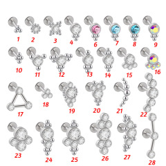 A pair of pierced earrings with a crystal cluster, featuring a G23 titanium and steel triangle lip-shaped lip ring, accented with 16 grams of CZ gemstones.