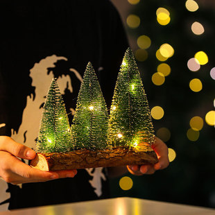 Creative new desktop Christmas tree ornaments mini Christmas tree with lights glowing scene festive atmosphere layout