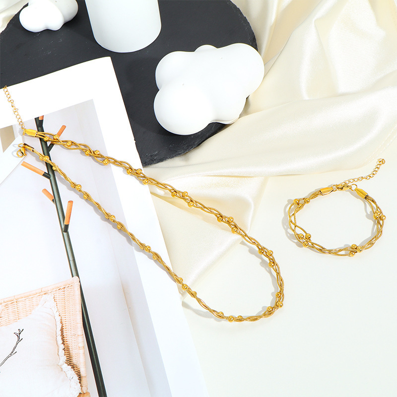 Ins-style minimalist braided necklace and bracelet set with small gold beads, designed for women. Wholesale of 18k gold-plated jewelry