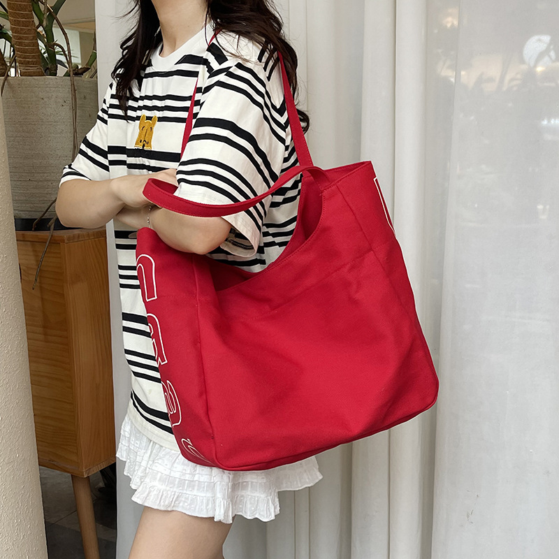 Bolso Tote de moda coreana 2025 verano nuevo estilo bolso femenino casual alfabeto bolso de hombro de lona estilo universitario