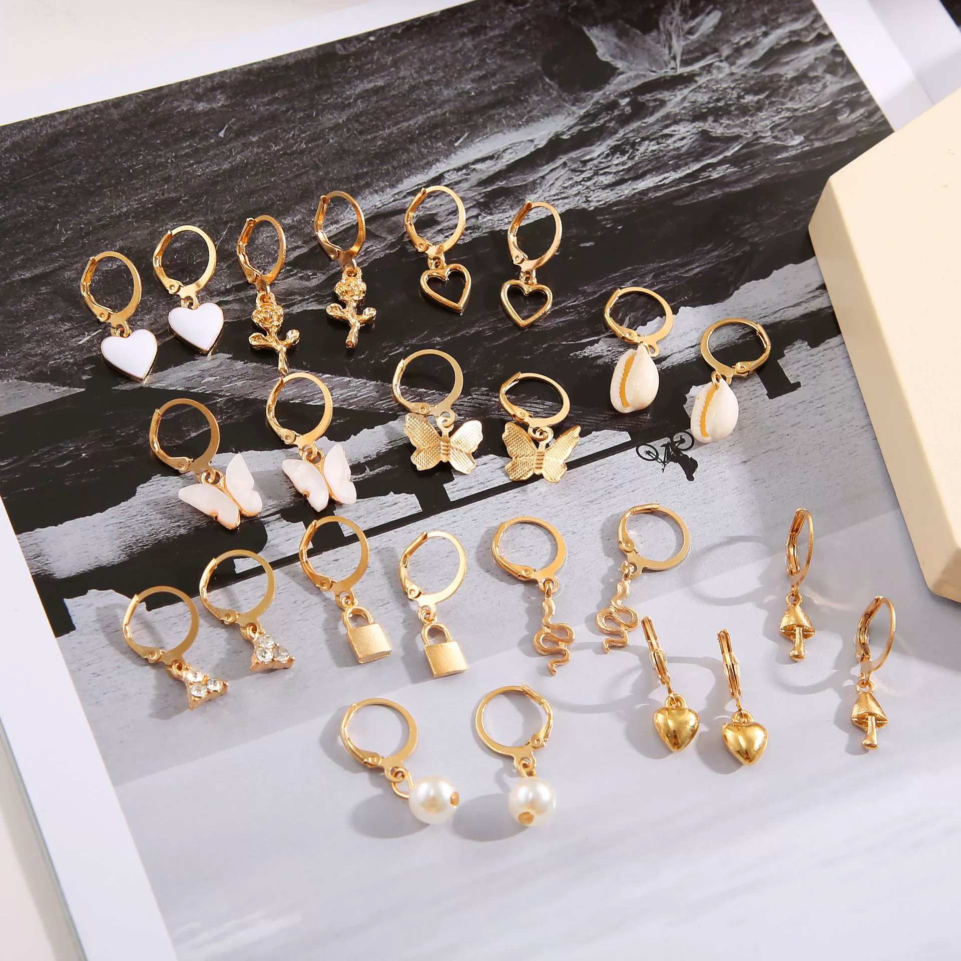 Pearl earrings set, gold‑tone multi‑pair on display card, assorted charm styles