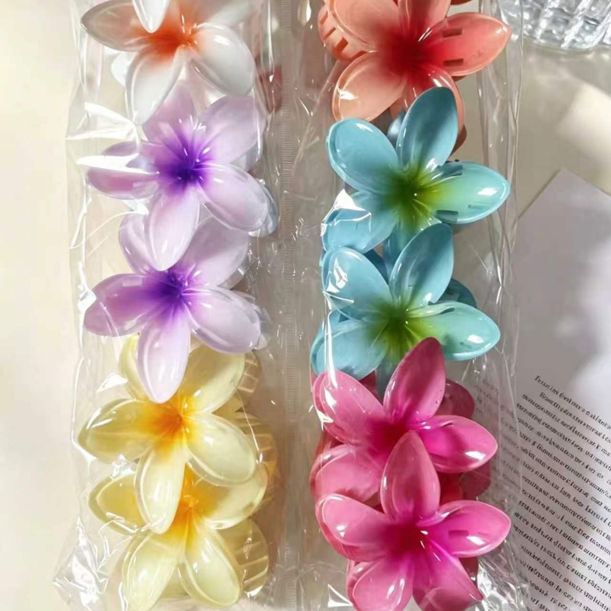 Vacancias de verano transfronterizas huevo flor clip para el cabello de mujeres tarjeta de sensibilidad avanzada 2026 nuevo conjunto de adornos para el cabello de flores laterales